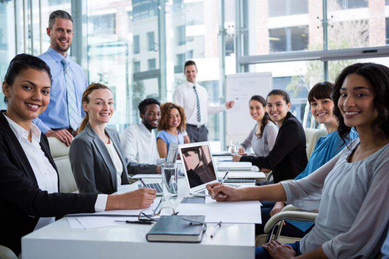 Portrait of happy businesspeople working in office