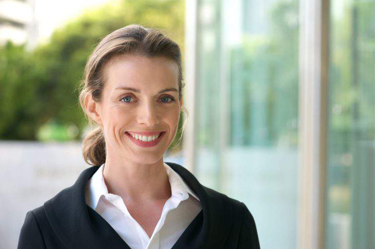 Smiling business woman with black jacket and white shirt